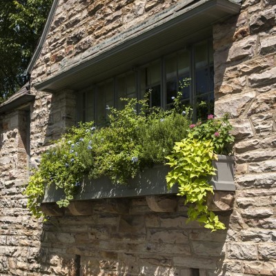 window container garden on stone house